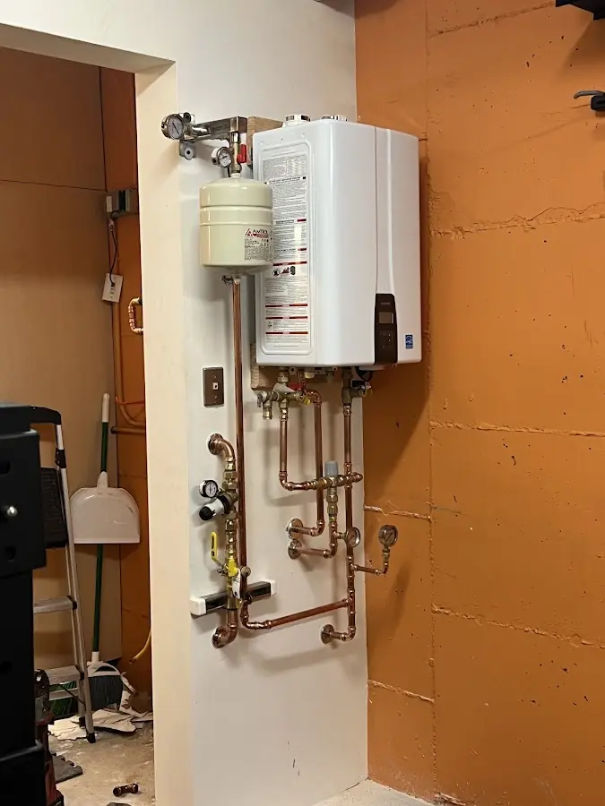 Plumbing technician inspecting water heater connections in Mill Valley